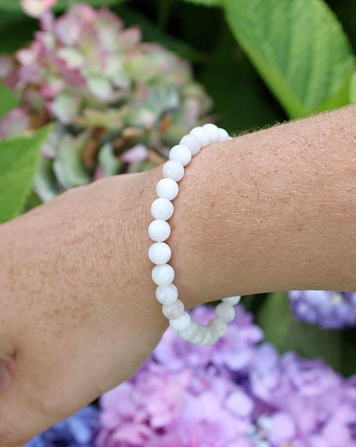 Moonstone 6mm Gemstone Bracelet on a wrist.