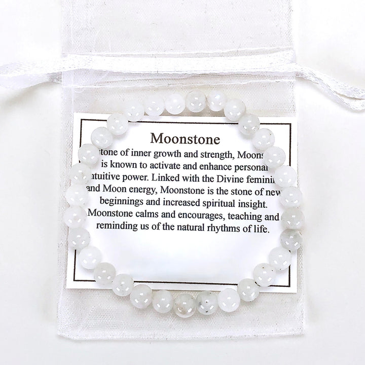 Moonstone 6mm Beaded Gemstone Bracelet with a description card.