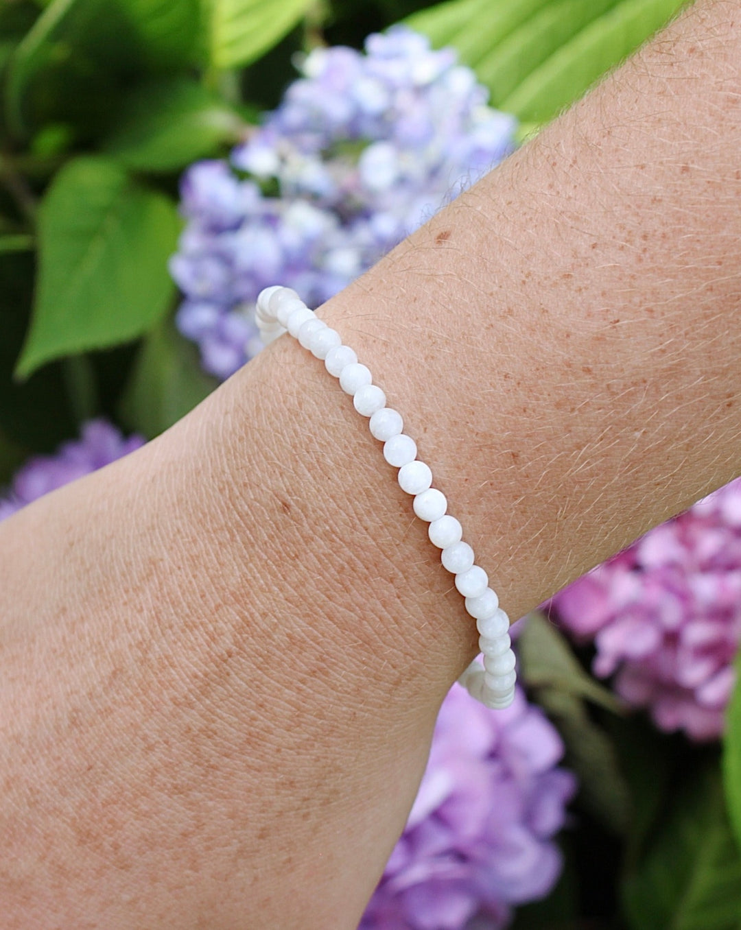 Moonstone 4mm Beaded Gemstone Bracelet on a wrist.