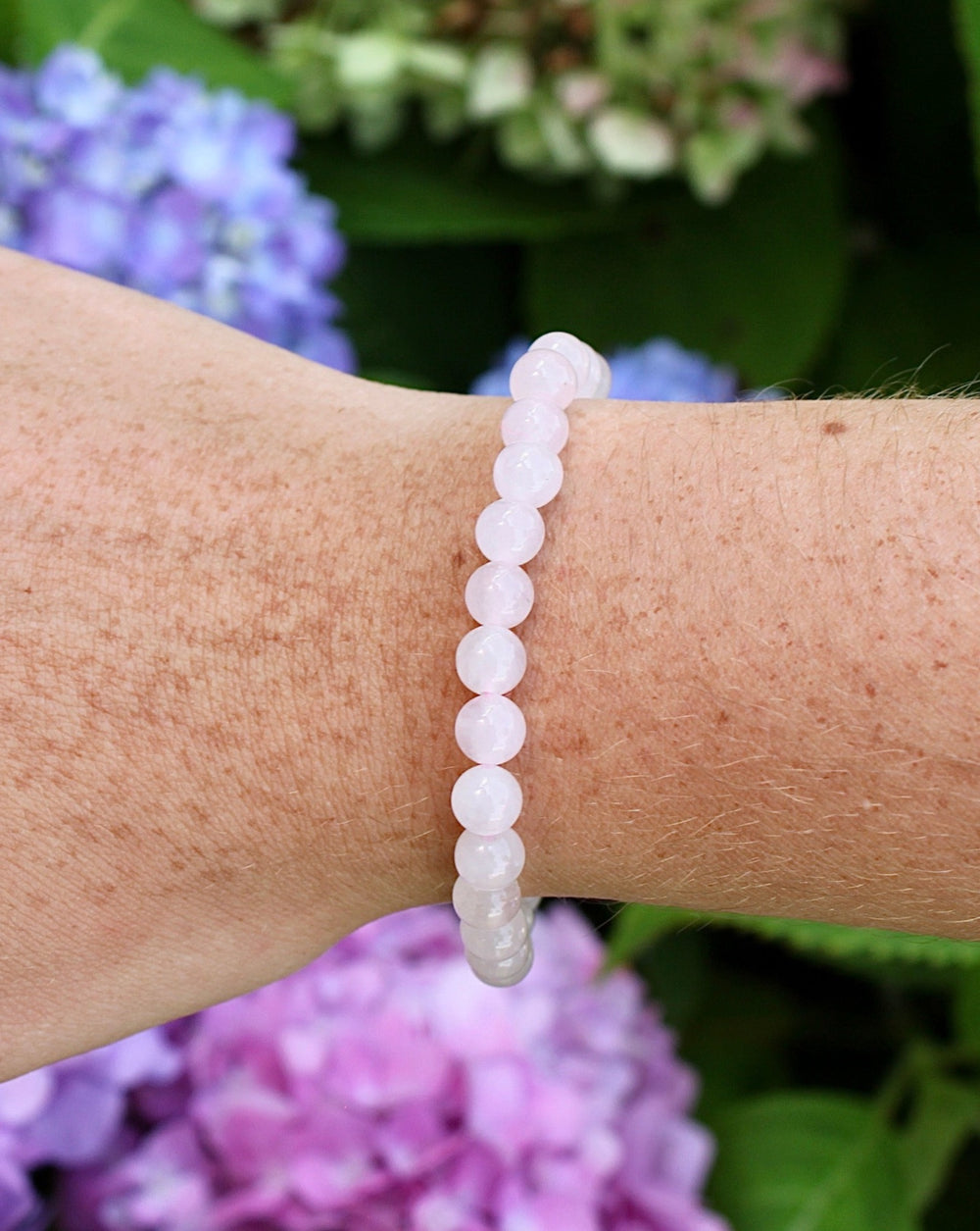 Moonstone 6mm Beaded Gemstone Bracelet on a wrist.