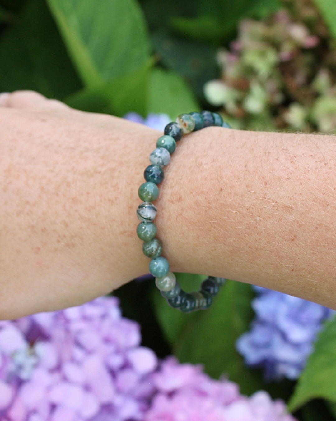 Moss Agate 6mm Beaded Gemstone Bracelet on a wrist.