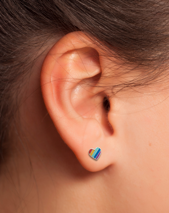 Sterling Silver Rainbow Heart Earring on an ear.