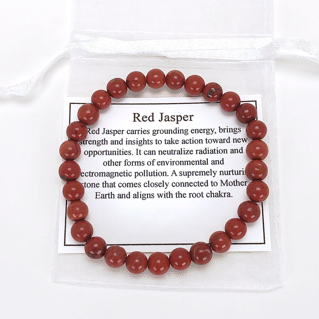 Red Jasper 6mm Beaded Gemstone Bracelet with a description card.