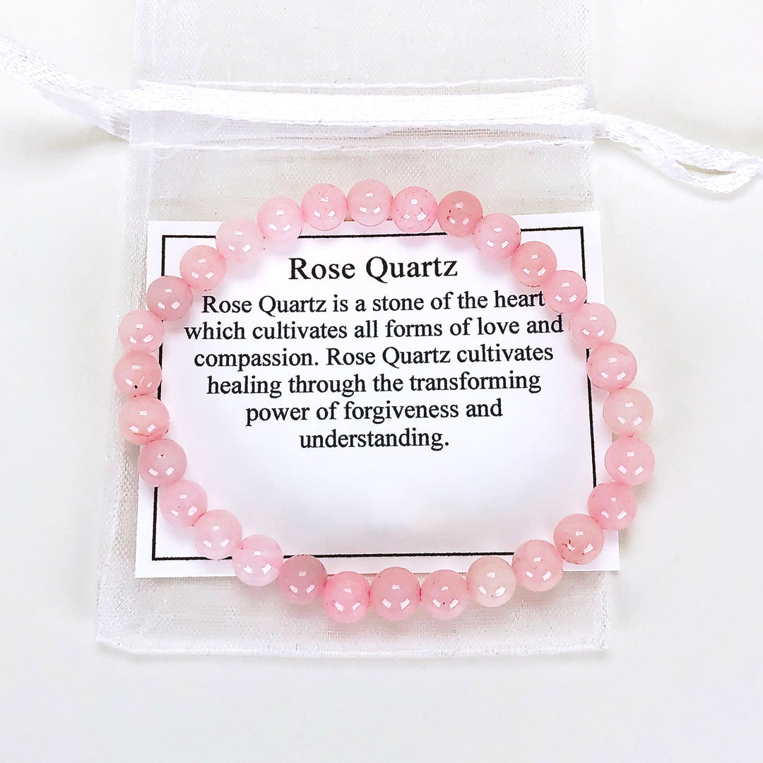 Rose Quartz 6mm Beaded Gemstone Bracelet with a description card.