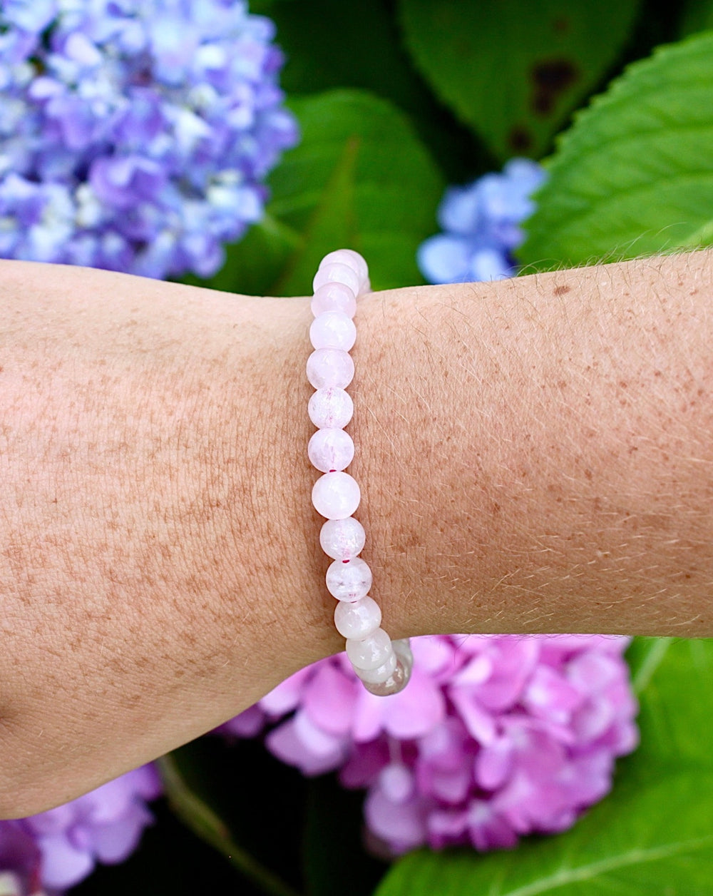 Rose Quartz 6mm Beaded Gemstone Bracelet on a wrist.