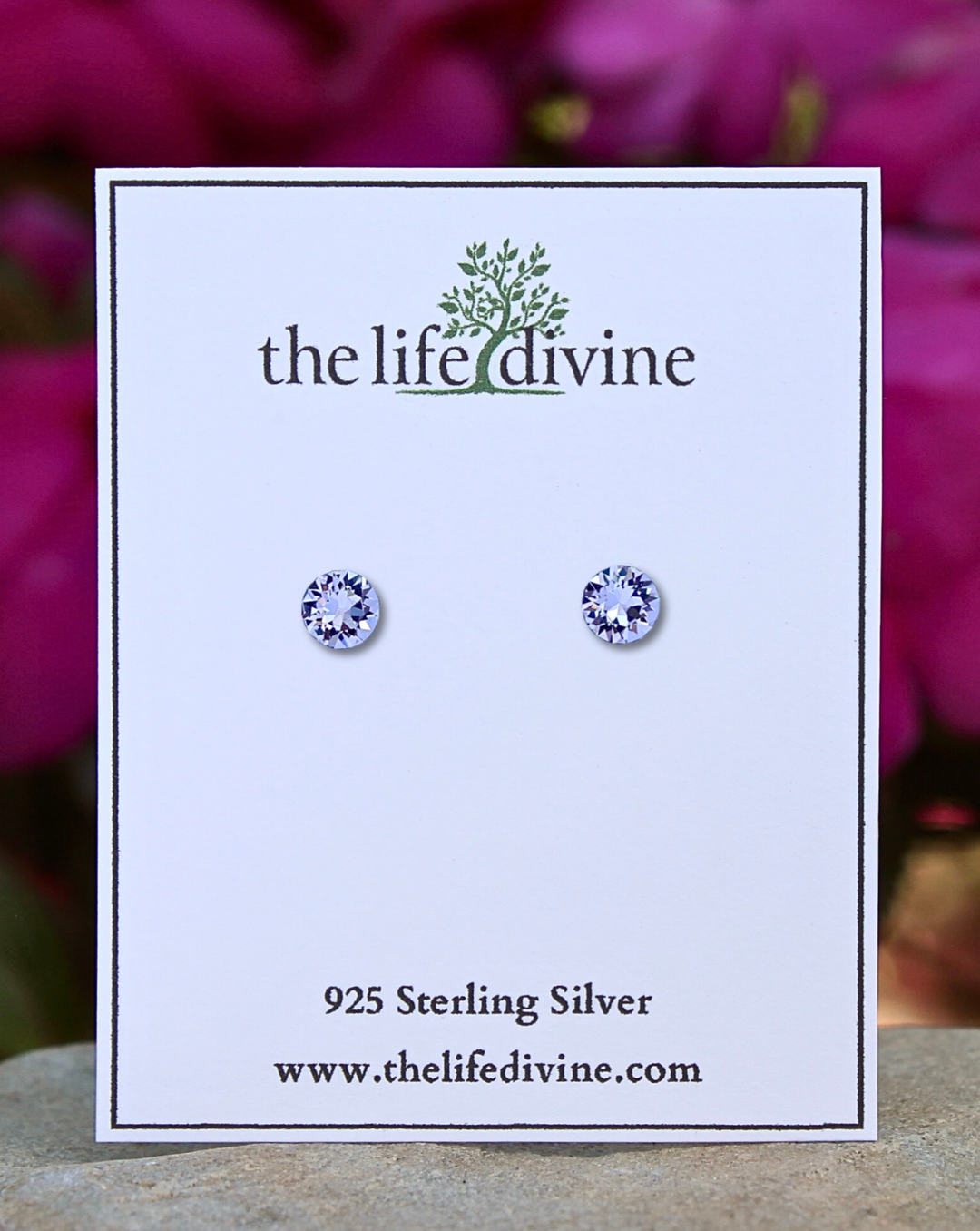 Round Lilac CZ Sterling Silver Earrings on a card.