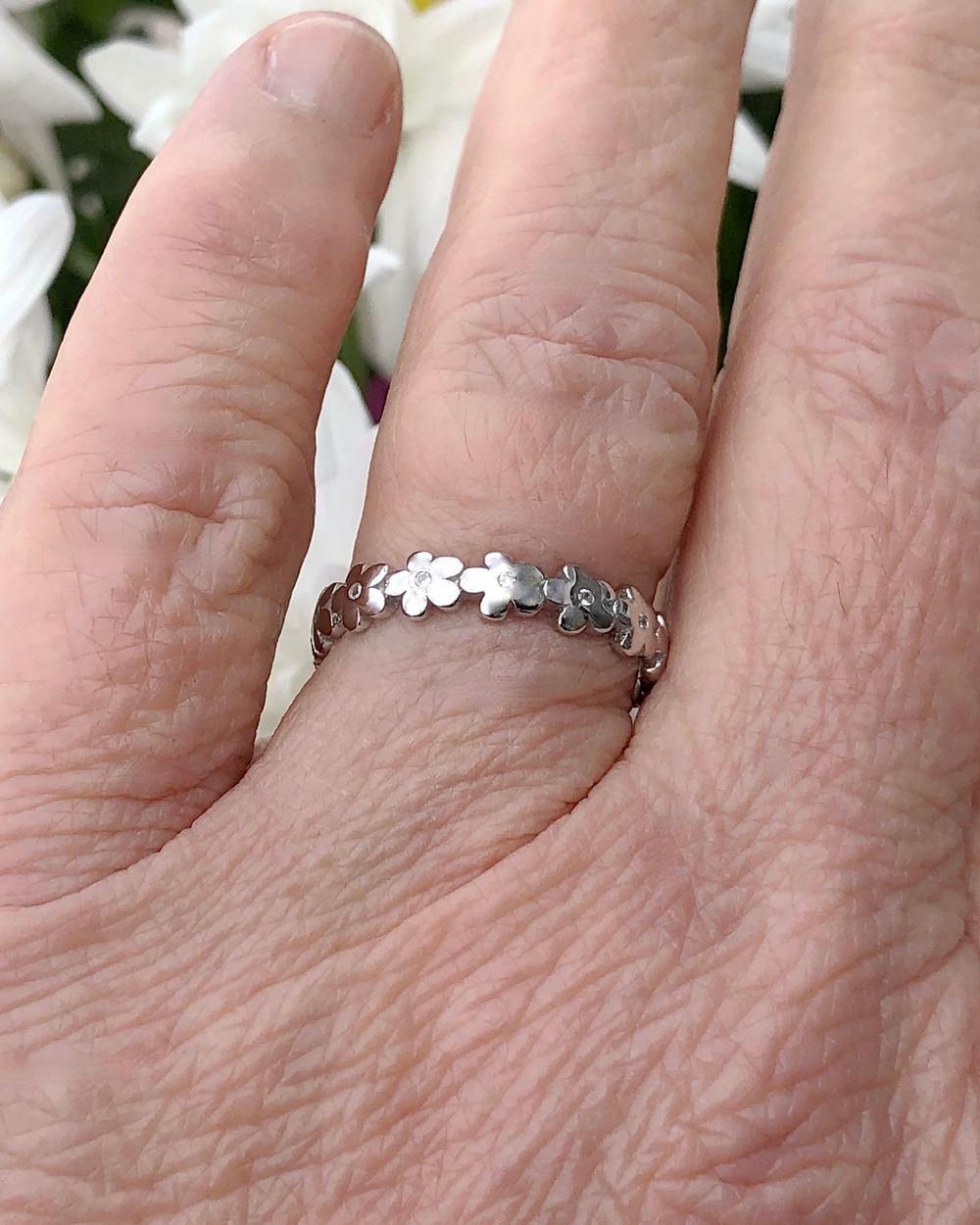 Silver Infinity Flower Ring with CZ Stones on finger