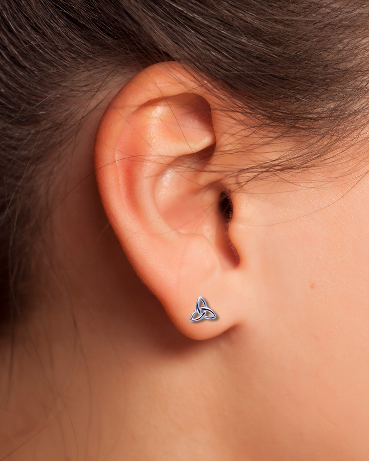 Triquetra Sterling Silver Earring on an ear.