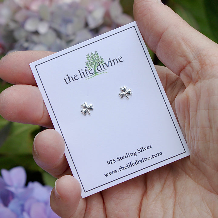 Carded Shamrock Sterling Silver Earrings in a hand.