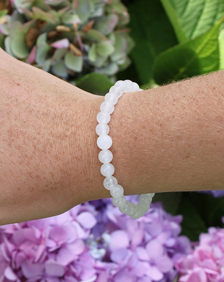 Snow Quartz 6mm Beaded Gemstone Bracelet on a wrist.