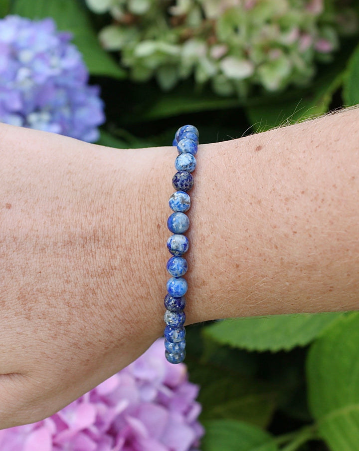 Sodalite 6mm beaded gemstone bracelet on a wrist