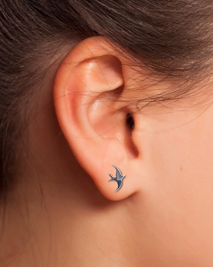 Sparrow Sterling Silver Earring on an ear.