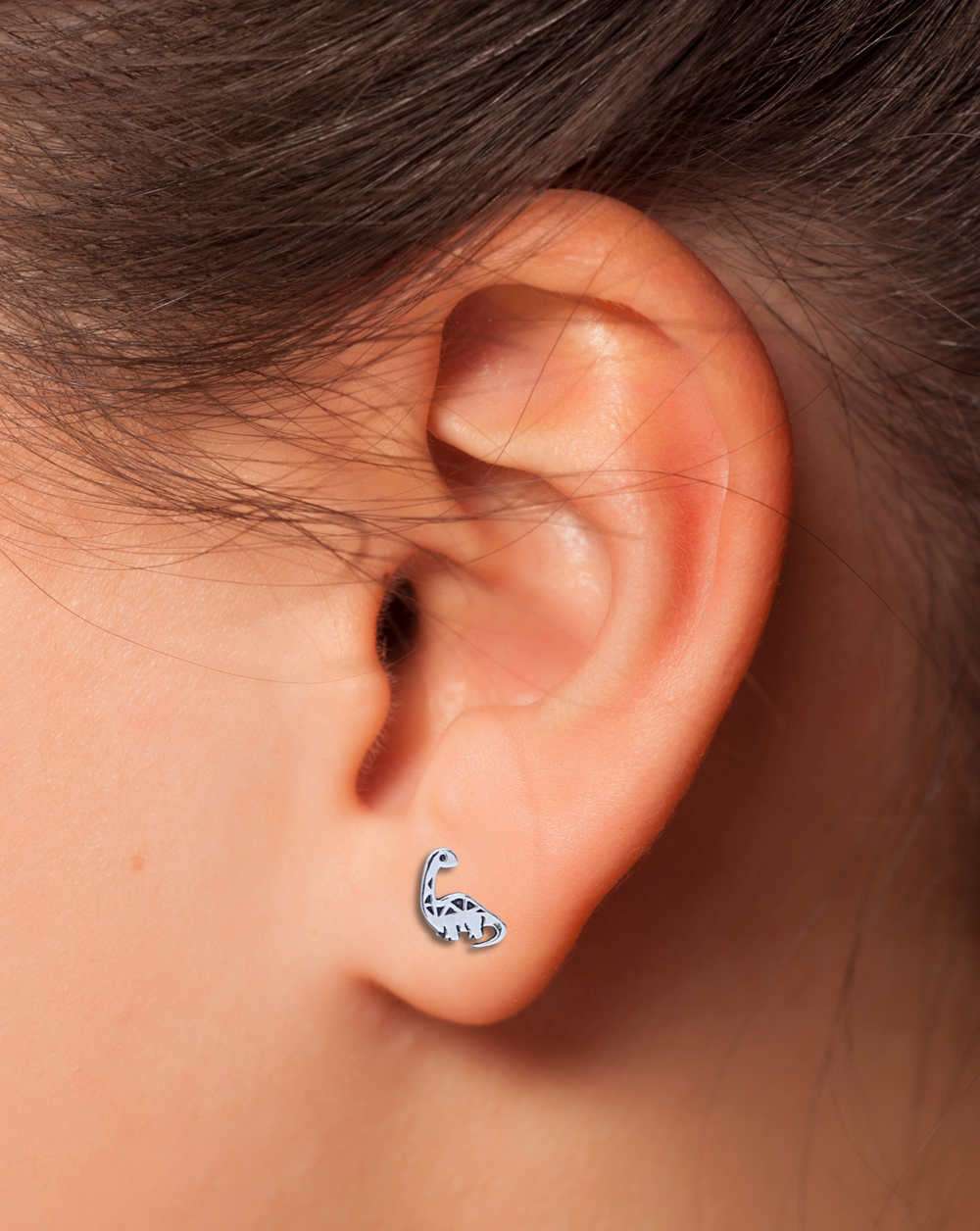 Sterling Silver Dinosaur Stud Earrings on ear