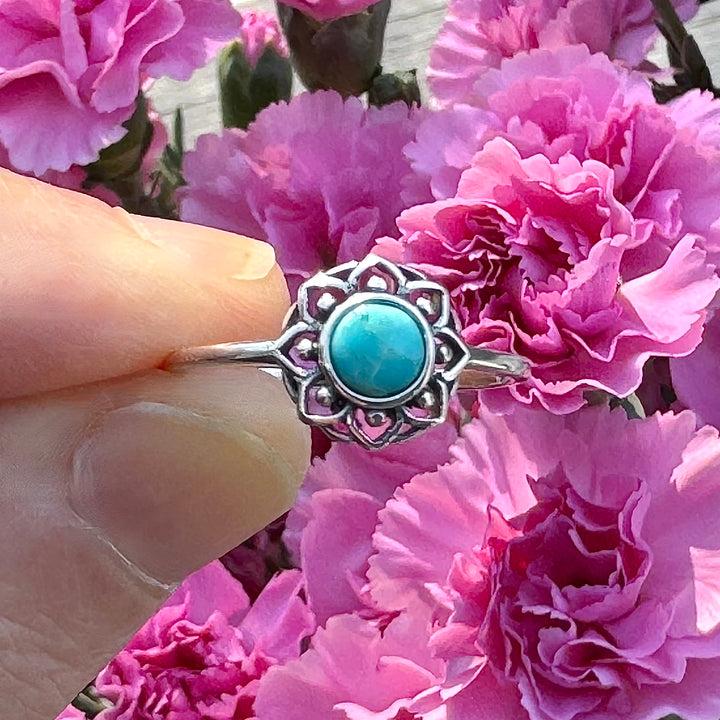 Sterling Silver Turquoise Lotus Flower Ring between fingers
