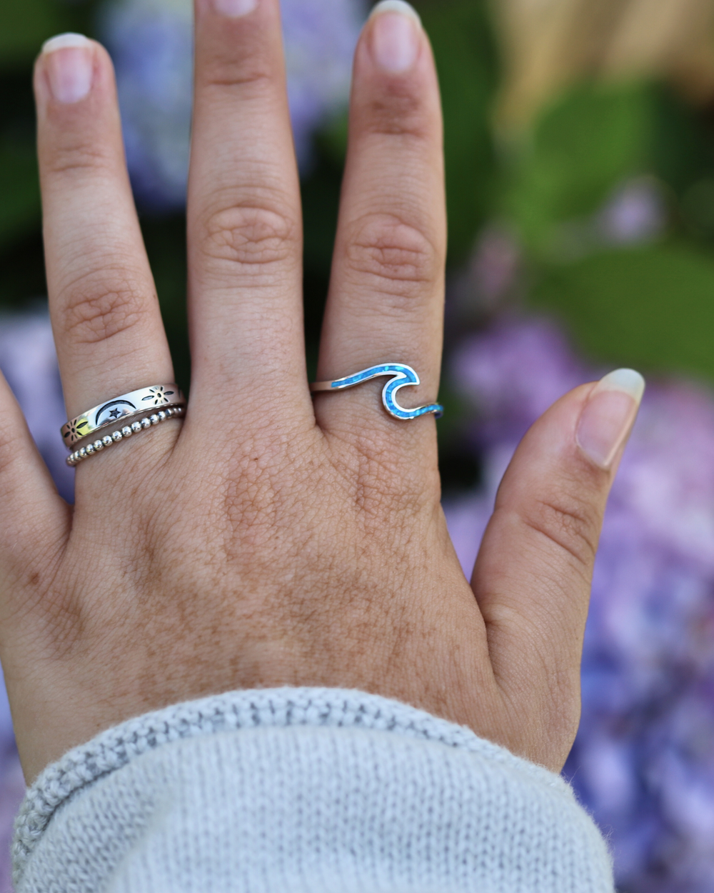 Sterling Silver Wave Ring with Blue Lab Opal on finger with stacked rings