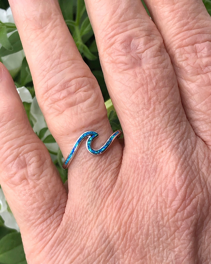 Sterling Silver Wave Ring with Blue Lab Opal on selenite on finger