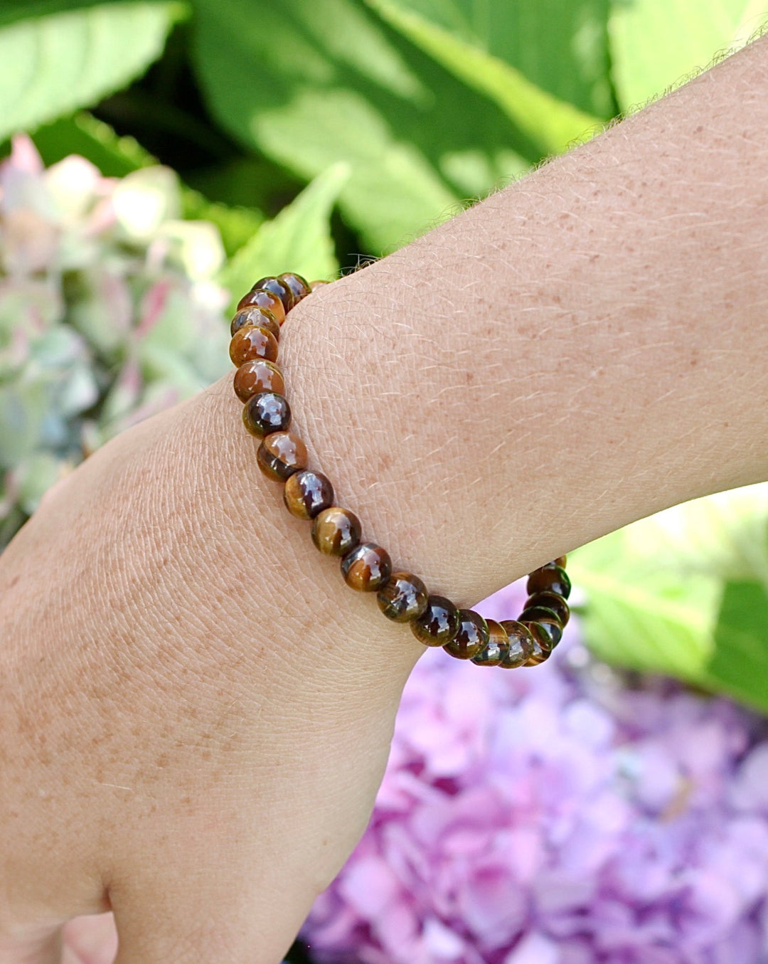 Tiger Eye 6mm Beaded Gemstone Bracelet on a wrist.