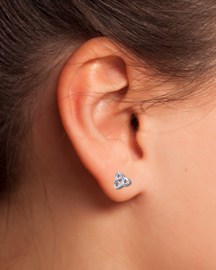 Triquetra Silver Stud Earring on an ear.