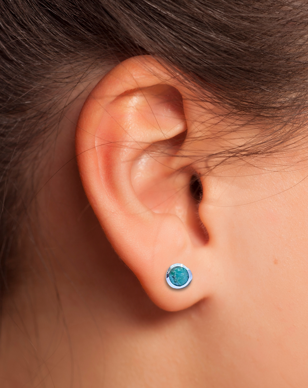 Turquoise Silver Earring on an ear.