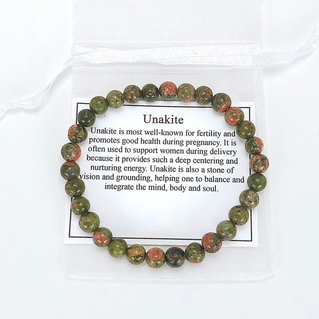 Unakite 6mm Beaded Gemstone Bracelet with a description card.