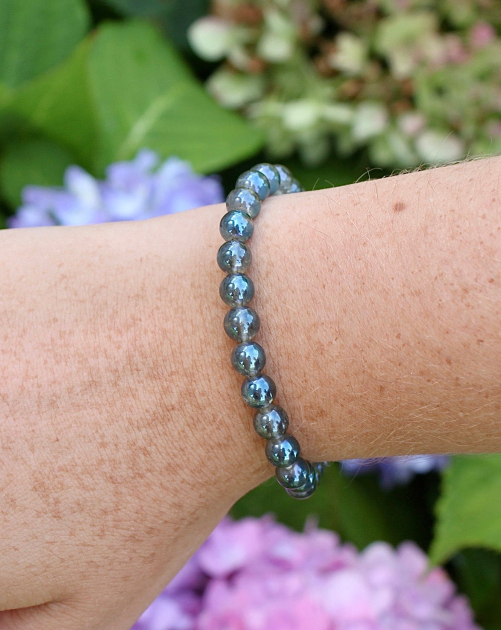 Aqua Aura 6mm beaded Gemstone Bracelet on a wrist