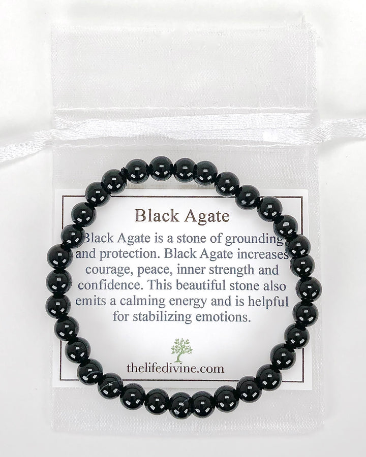 Black Agate 6mm Beaded Gemstone Bracelet with a description card.