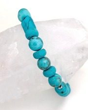 Turquoise gemstone elastic Bracelet closeup with quartz crystal
