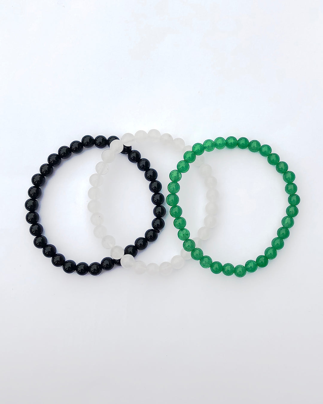  Aventurine, Snow Quartz and Black Agate Gemstone Bracelets on a white background.