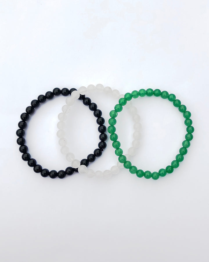 Aventurine, Snow Quartz and Black Agate Gemstone Bracelets on a white background.