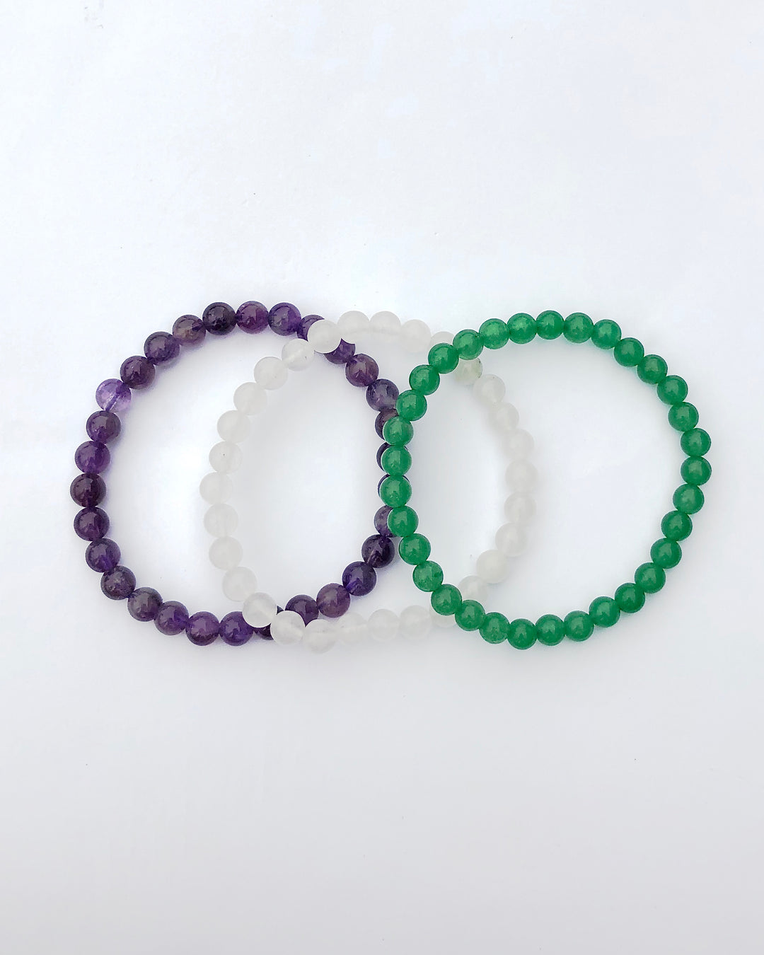 Amethyst, Snow Quartz and Aventurine 6mm beaded Gemstone Bracelet Set for Tranquility on a white background.