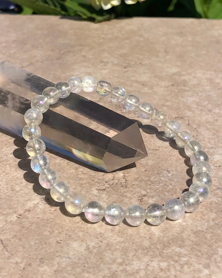 Angel Aura 6mm Beaded Gemstone Bracelet on a crystal