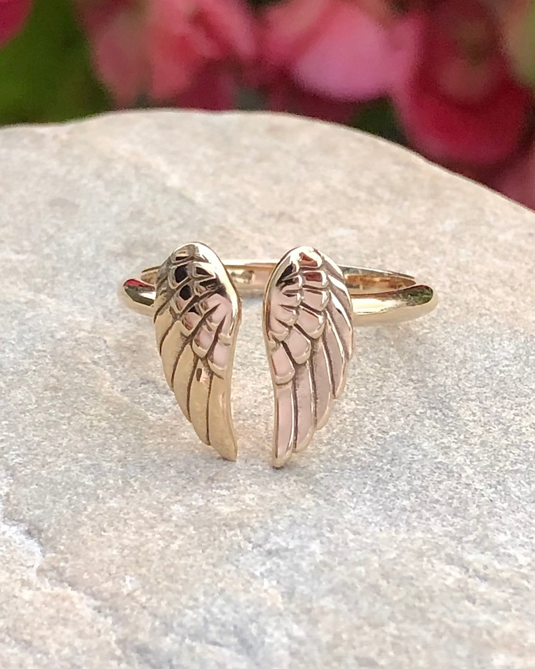 Angel Wings Adjustable Bronze Ring close up on stone