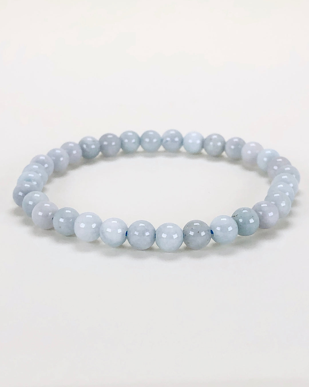 Aquamarine 6mm Beaded Gemstone Bracelet on a white background.