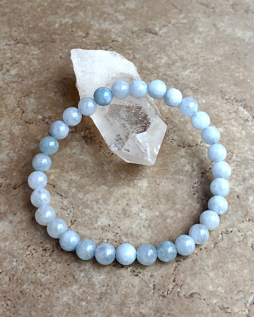 Aquamarine 6mm Beaded Gemstone Bracelet on a crystal