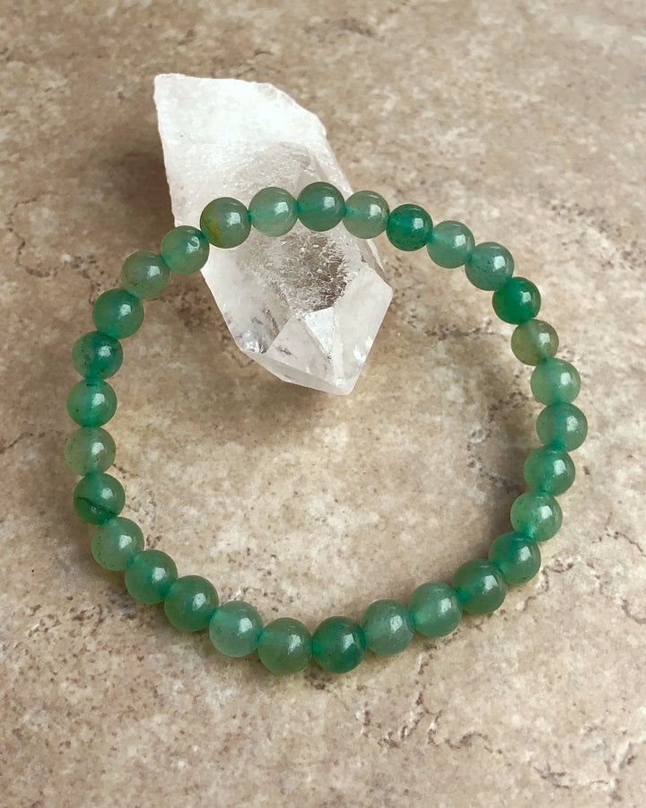 Aventurine 6mm Beaded Gemstone Bracelet on a crystal.