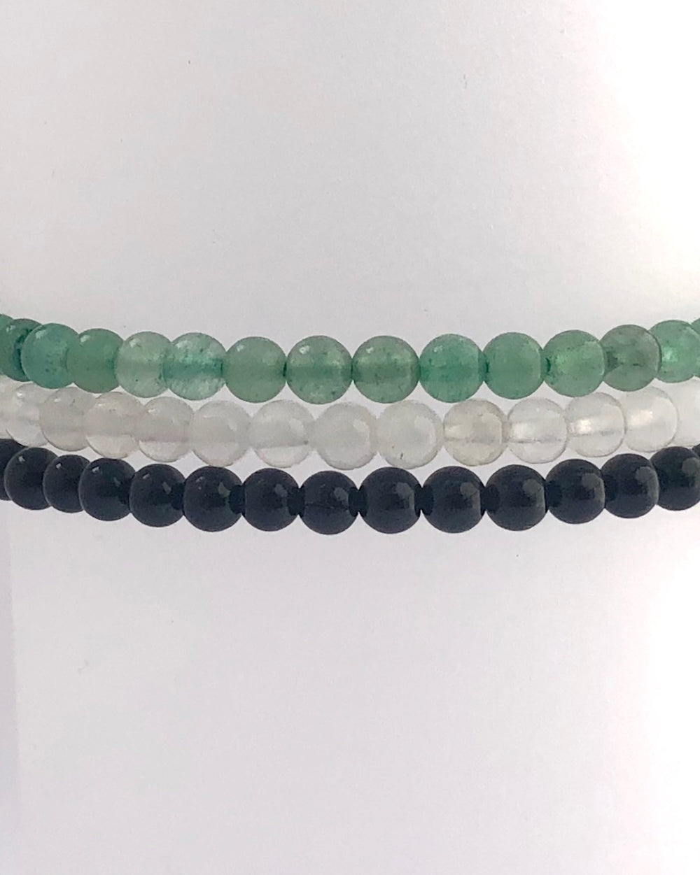 Aventurine, Snow Quartz and Black Agate stacked bracelets.