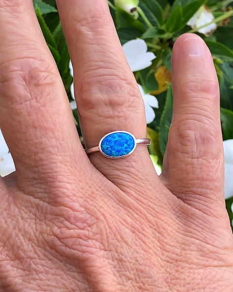 Sterling Silver Oval blue lab opal ring on ring finger 