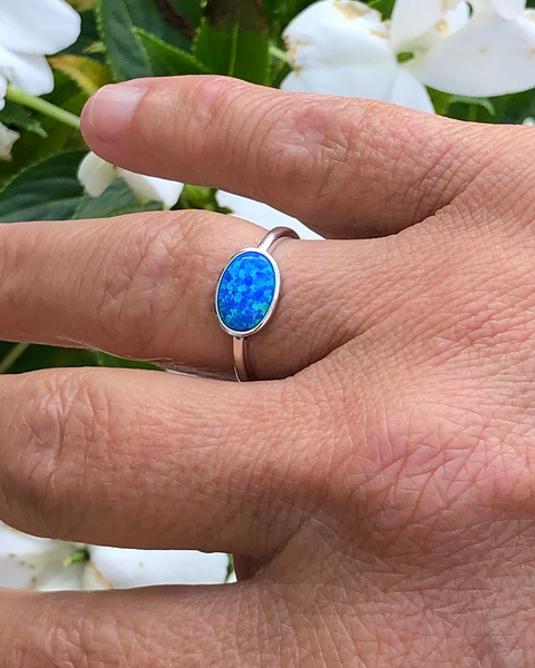 Sterling Silver Oval blue lab opal ring on ring finger 