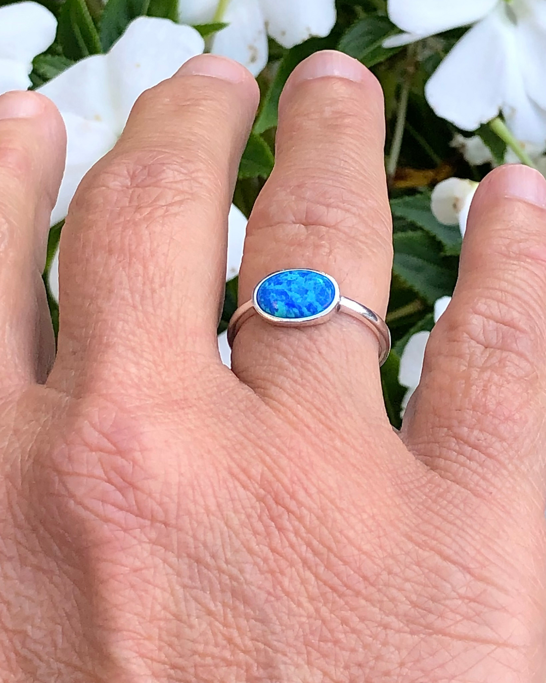 Sterling Silver Oval blue lab opal ring on ring finger 