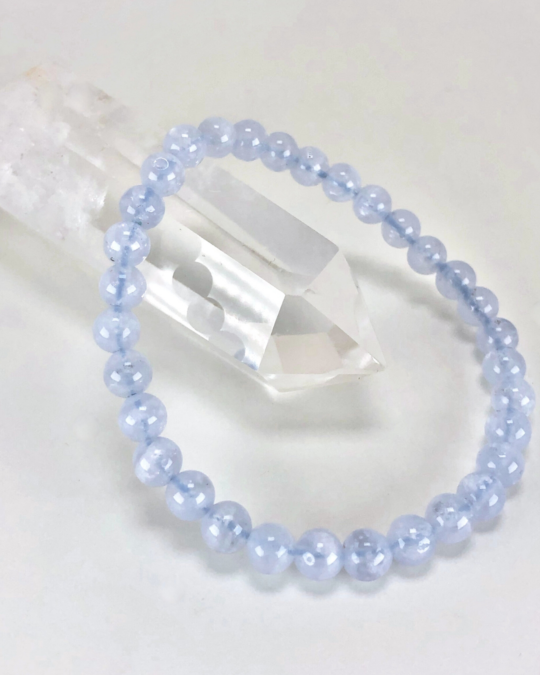 Blue Lace Agate 6mm Beaded Gemstone Bracelet on a crystal.