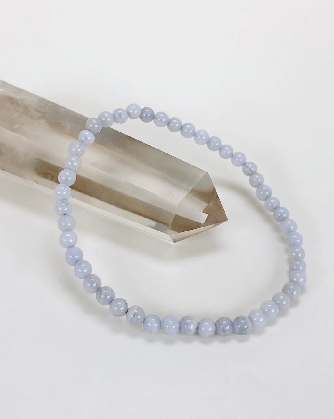 Men's Blue Lace Agate 4mm Beaded Gemstone Bracelet on a crystal