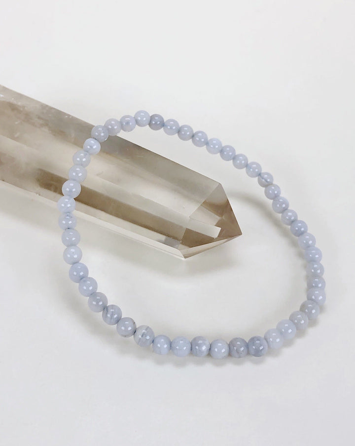 Men's Blue Lace Agate 4mm Beaded Gemstone Bracelet on a crystal