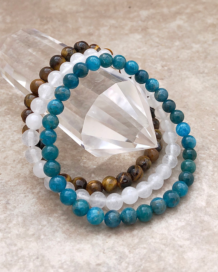 Apatite, Snow Quartz and Tiger Eye 6mm beaded Gemstone Bracelet Set for Courage and Truth on a crystal.