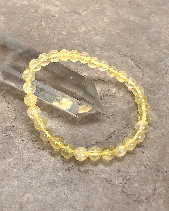 Citrine 6mm Beaded Gemstone Bracelet on a crystal.