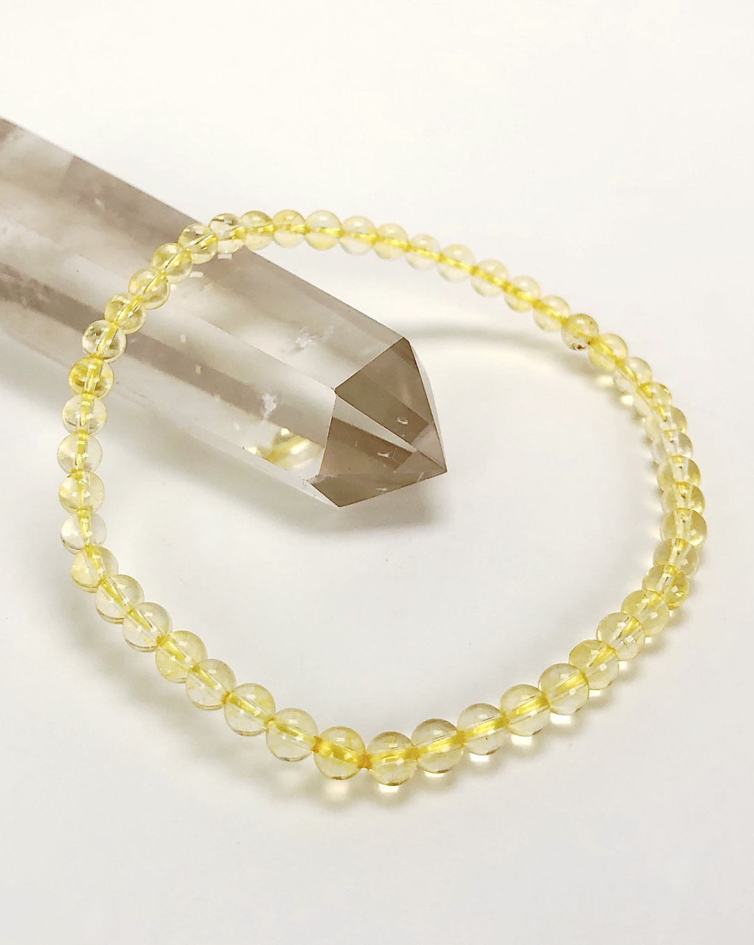 Men's Citrine 4mm Beaded Gemstone Bracelet on a crystal.