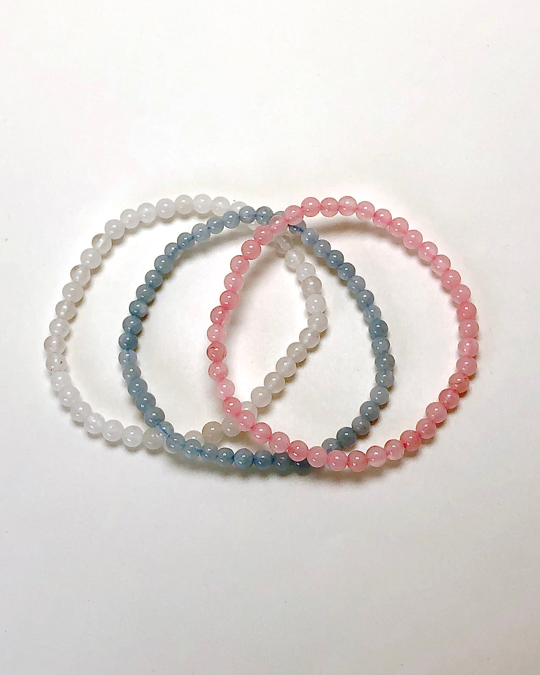 Fertility 4mm Gemstone Bracelet Set - Aquamarine, Snow Quartz and Rose Quartz on a white background