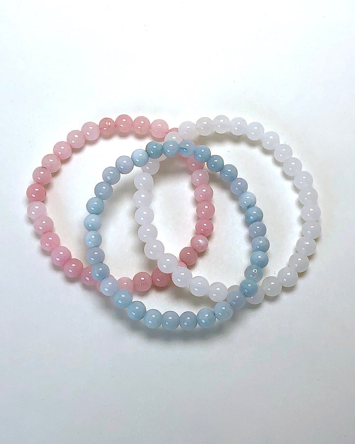 Fertility 6mm Beaded Gemstone Bracelet Set  with Snow Quartz, Rose Quartz and Aquamarine on a white background.