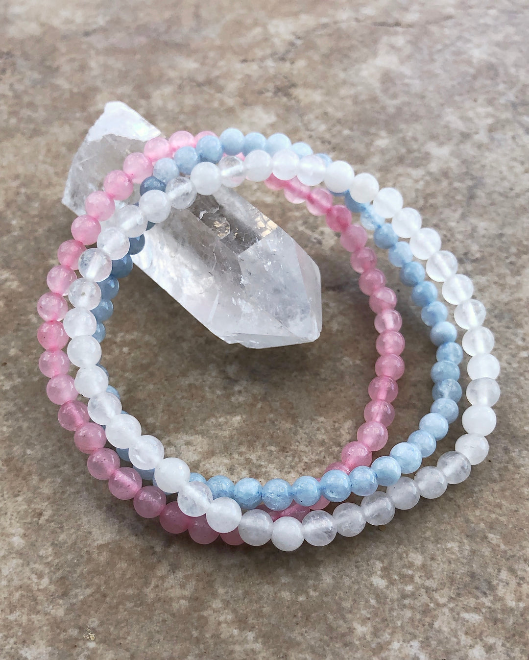 Fertility 4mm Gemstone Bracelet Set - Aquamarine, Snow Quartz and Rose Quartz on a crystal