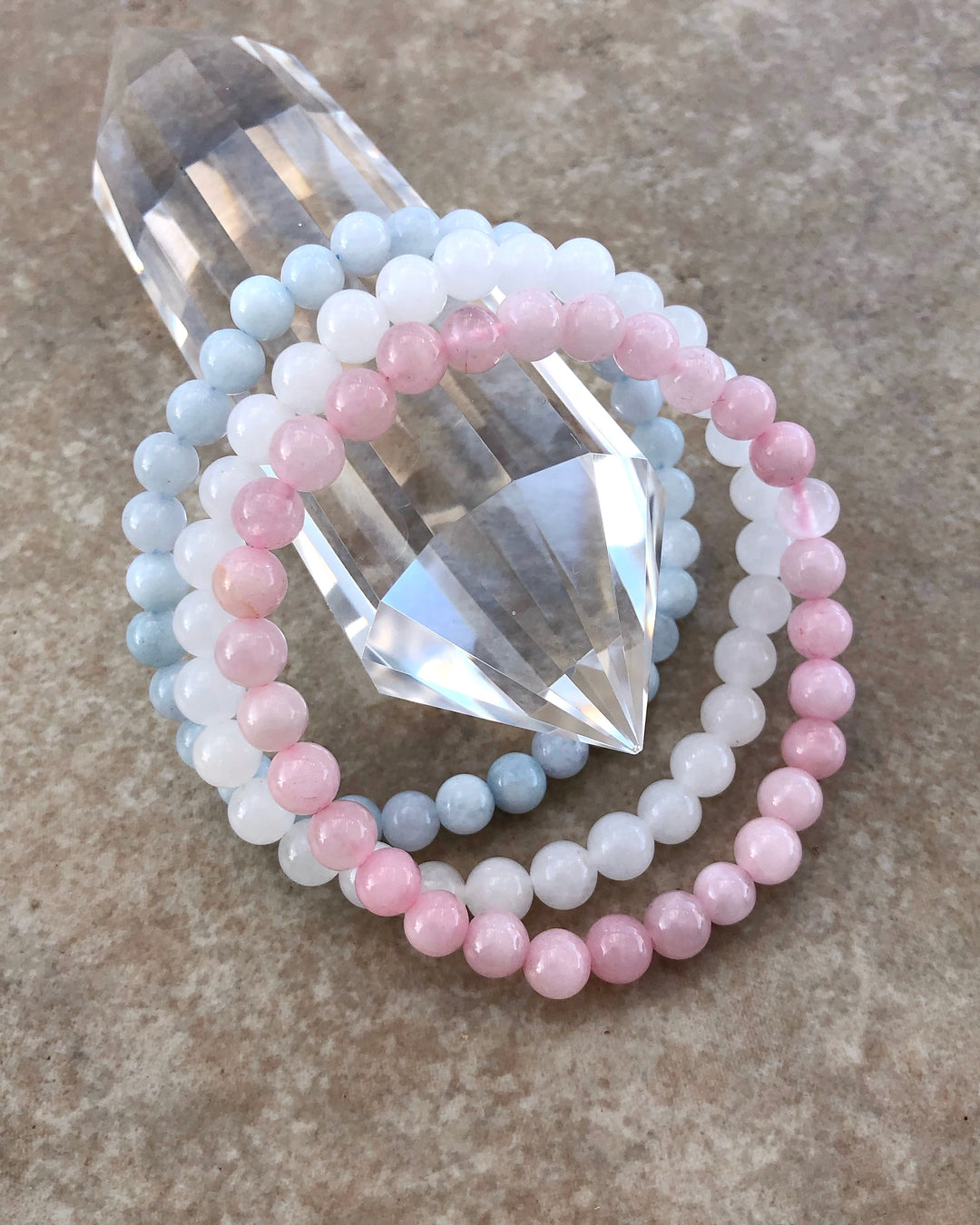 Fertility 6mm Beaded Gemstone Bracelet Set  with Snow Quartz, Rose Quartz and Aquamarine on a crystal.