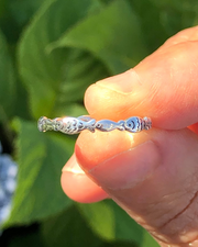 Sterling Silver Fish Ring held between fingers close up